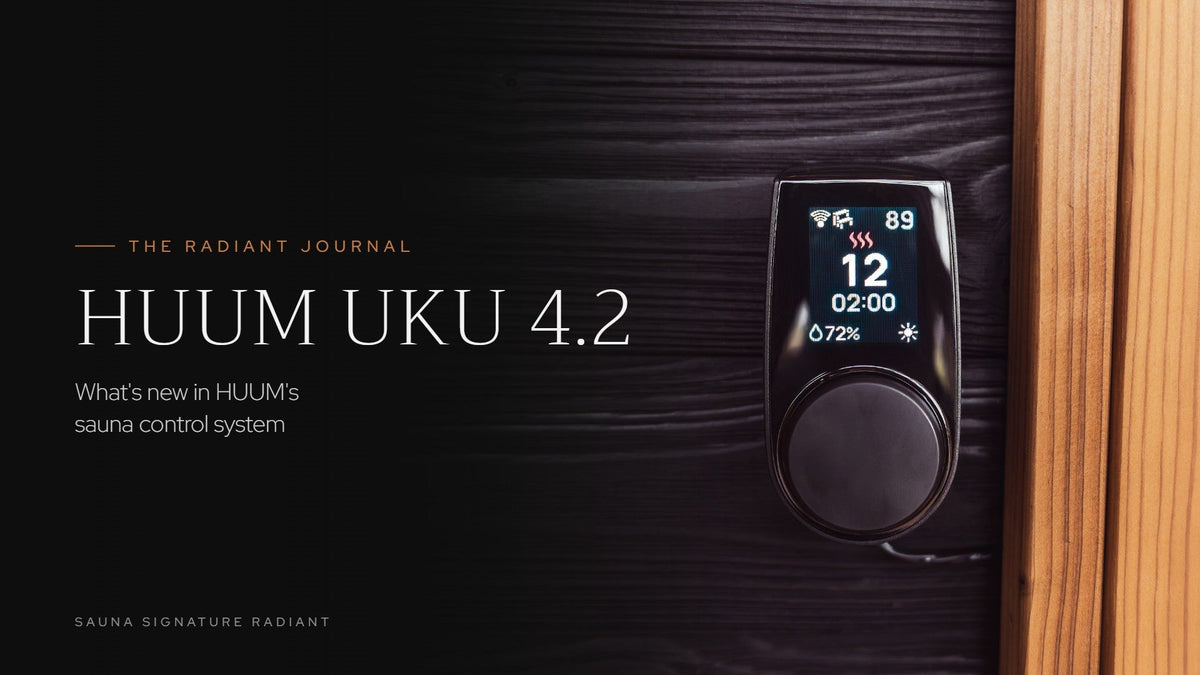HUUM UKU 4.2 Wi-Fi control panel showing temperature and humidity on a dark wood sauna wall