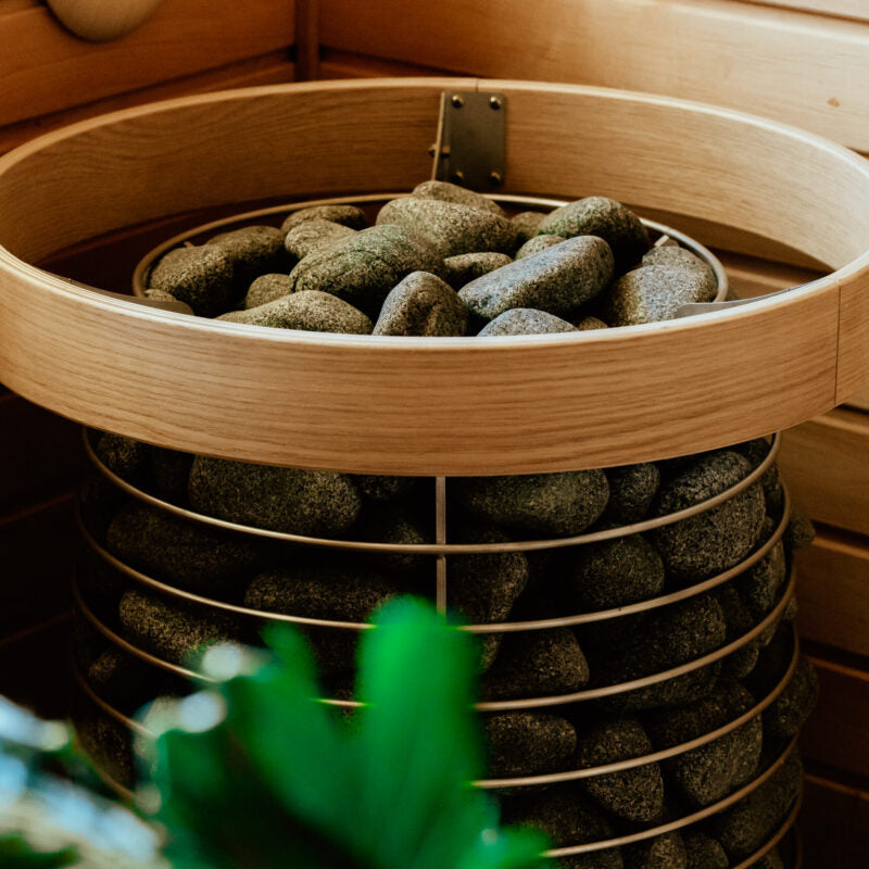 HUUM HIVE heater with wooden Safety Railing in a sauna
