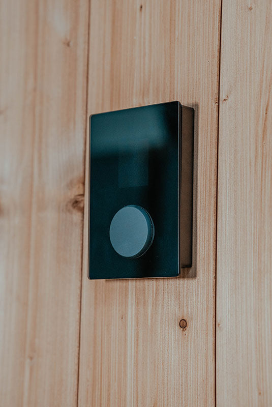 HUUM UKU Glass panel surface-mounted with the Surface Frame on a sauna wall
